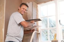 Plasterer repairing damaged walls